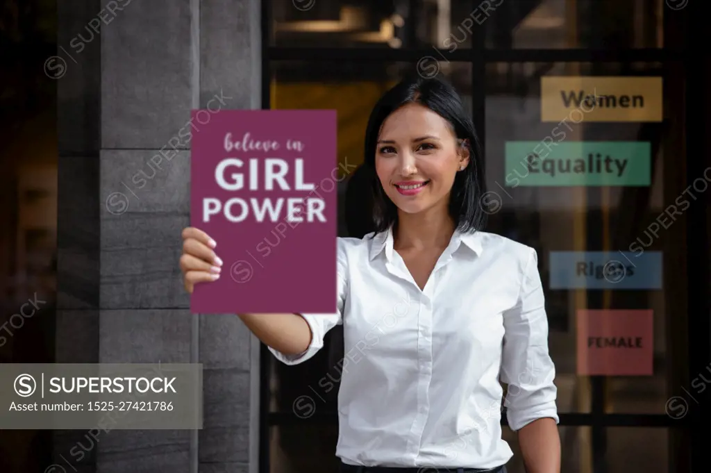 Equality for Women Gender Concept. a Smiling Mixed Races Woman showing a Board with Message Girl Power into the front