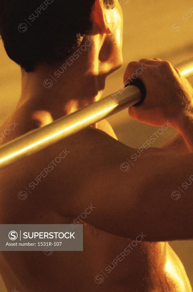 Stock Photo: 1531R-107 Rear view of a young man holding a javelin