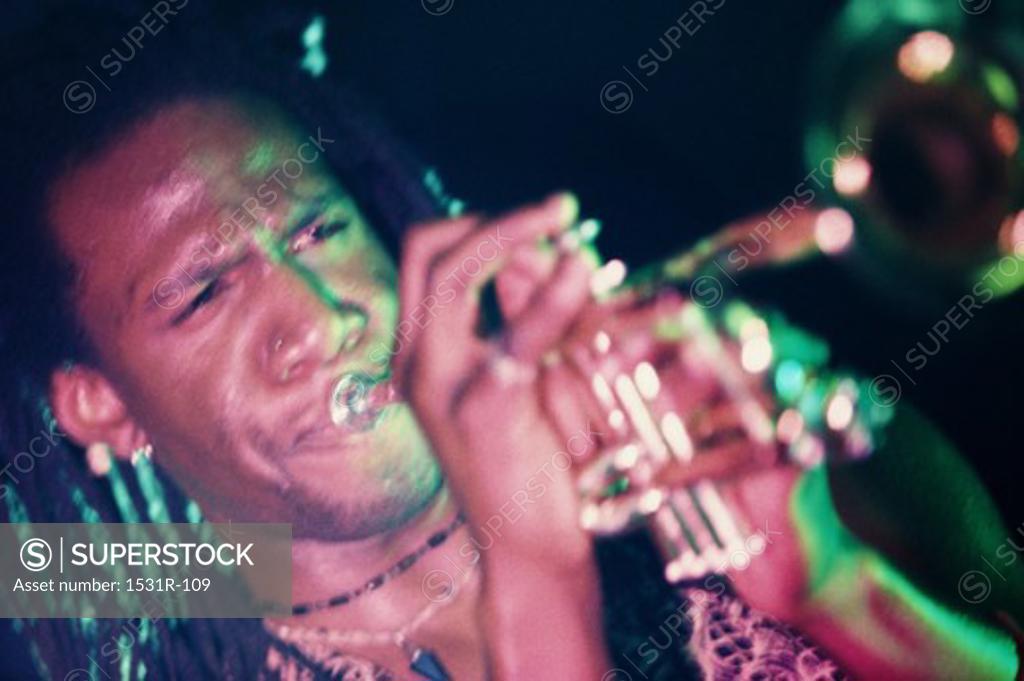 Stock Photo: 1531R-109 Young man playing the trumpet