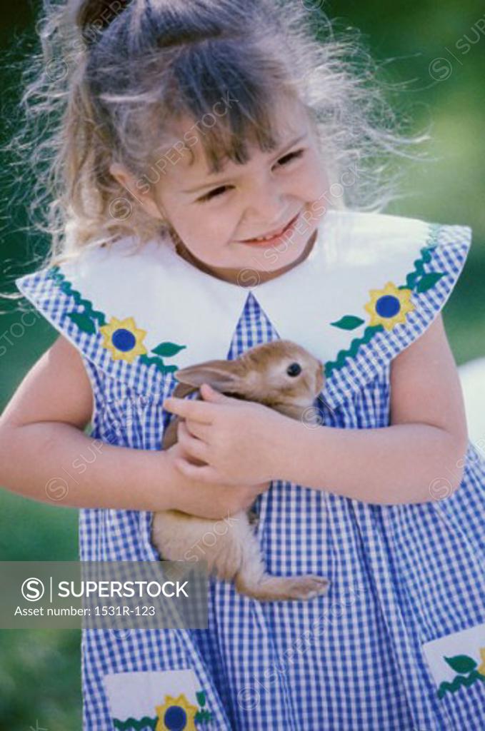 Stock Photo: 1531R-123 Girl holding a rabbit