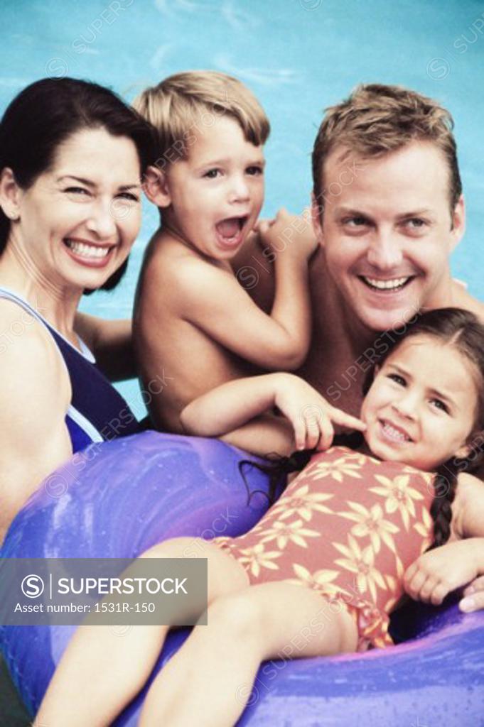 Stock Photo: 1531R-150 Portrait of a father and mother with their son and daughter in a swimming pool
