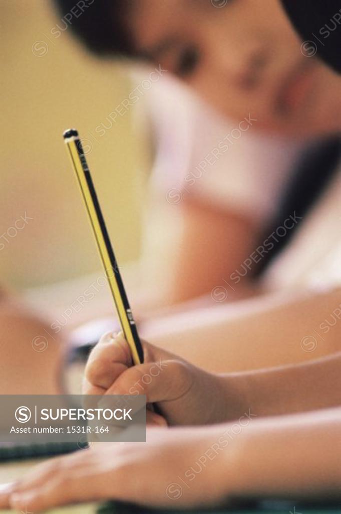 Stock Photo: 1531R-164 Close-up of a child's hand holding a pencil
