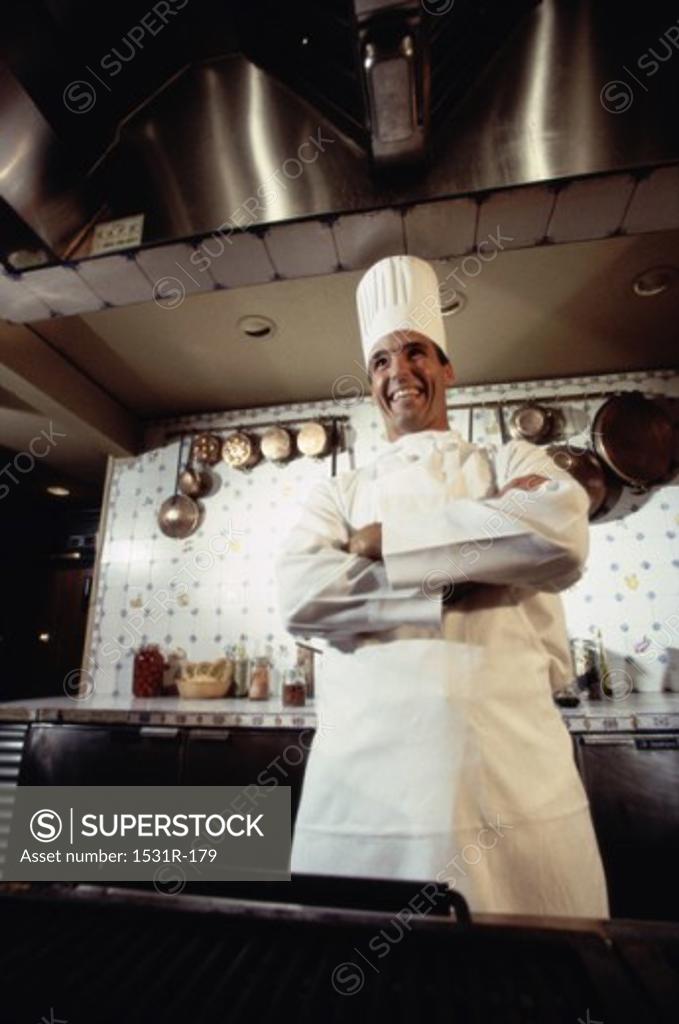 Stock Photo: 1531R-179 Chef standing in a kitchen with his arms folded