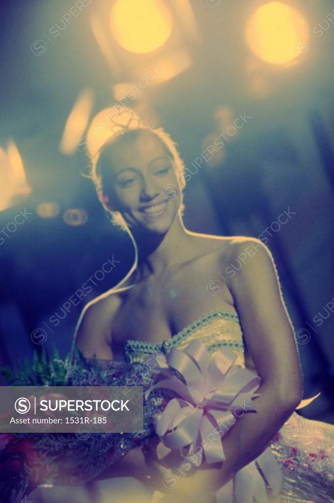 Stock Photo: 1531R-185 Young woman holding a bouquet of flowers smiling