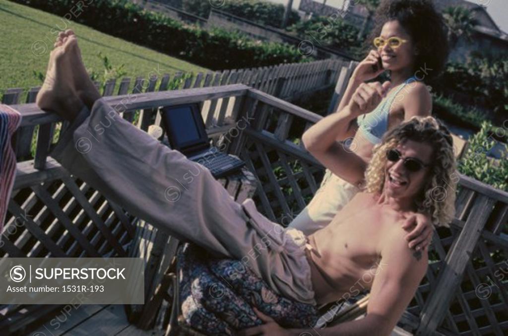 Stock Photo: 1531R-193 Young couple sitting on a porch
