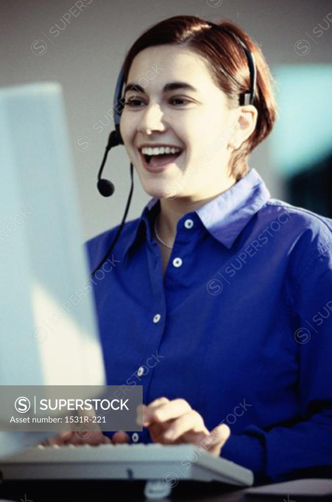 Stock Photo: 1531R-221 Customer service representative working on a computer smiling