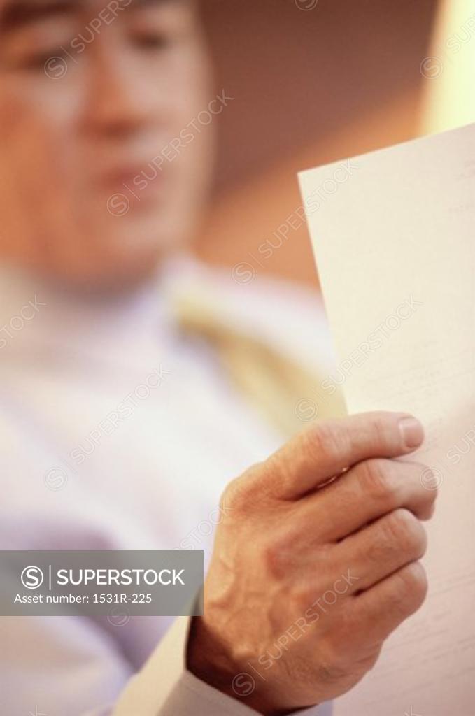 Stock Photo: 1531R-225 Businessman reading a sheet of paper
