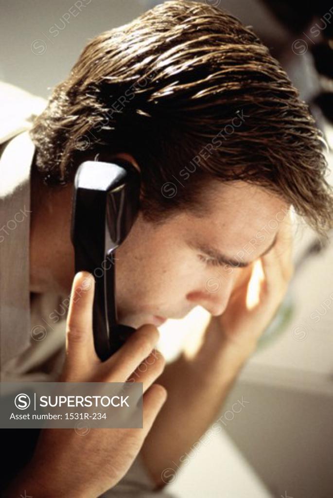 Stock Photo: 1531R-234 Close-up of a businessman talking on a landline telephone