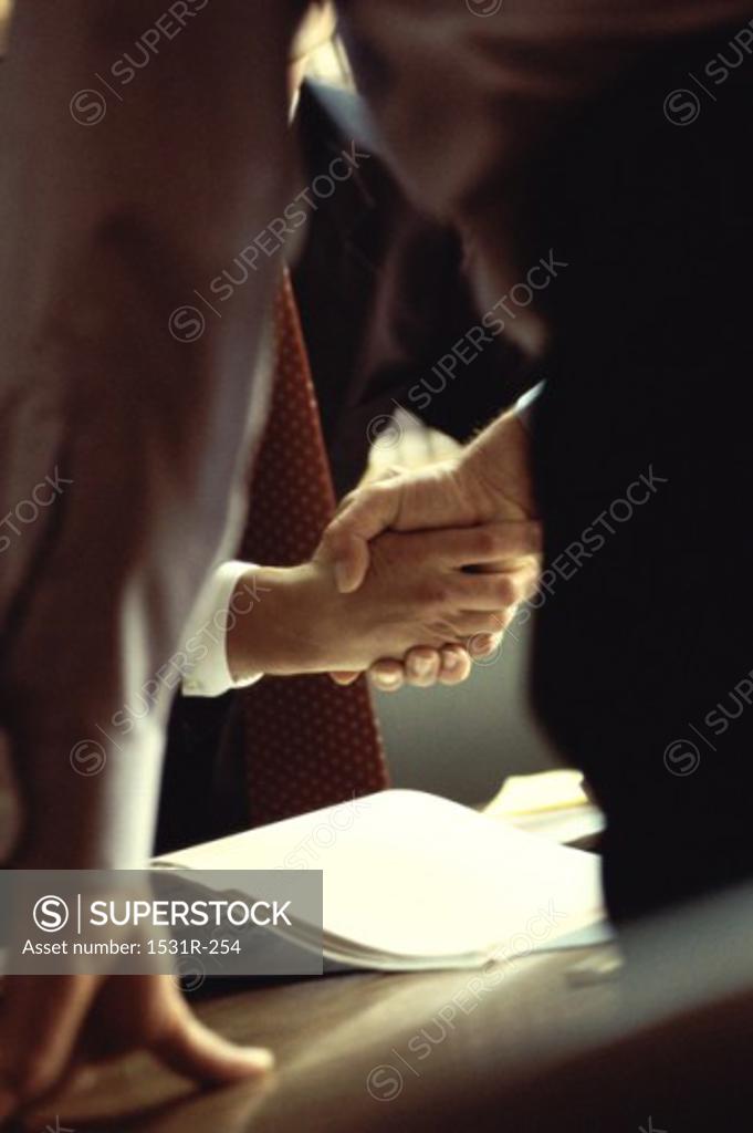Stock Photo: 1531R-254 Mid section view of two businessmen shaking hands
