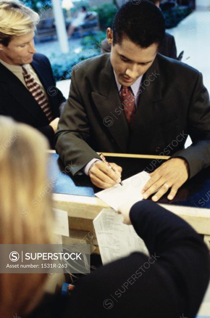 Stock Photo: 1531R-263 Close-up of a businessman standing at a checkout counter