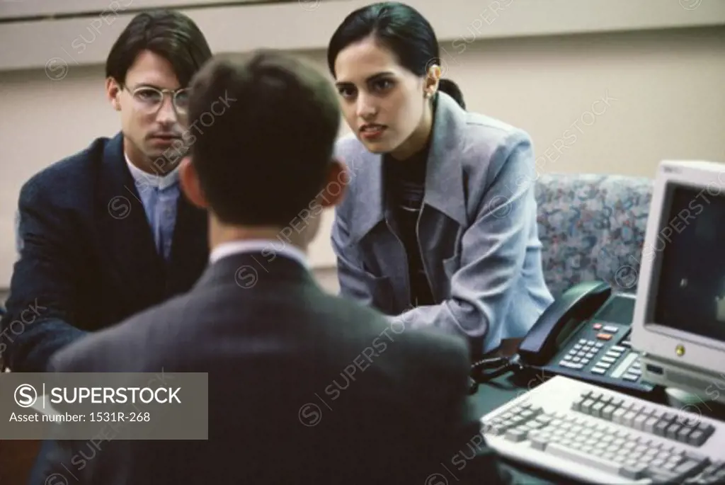 Three business executives in a meeting