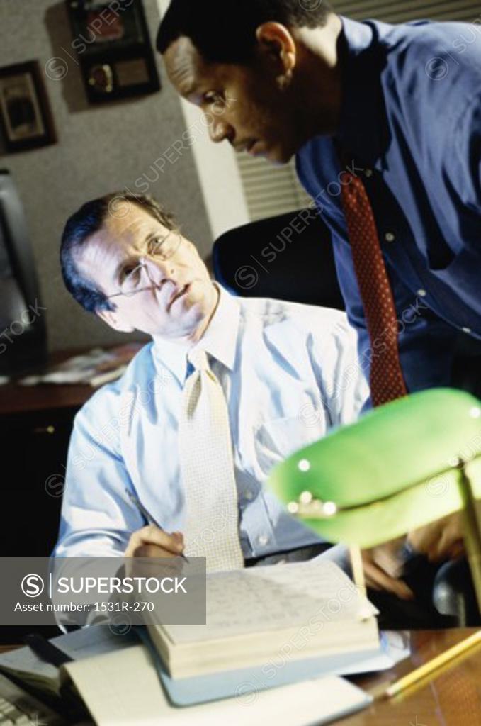 Stock Photo: 1531R-270 Two businessmen talking in an office