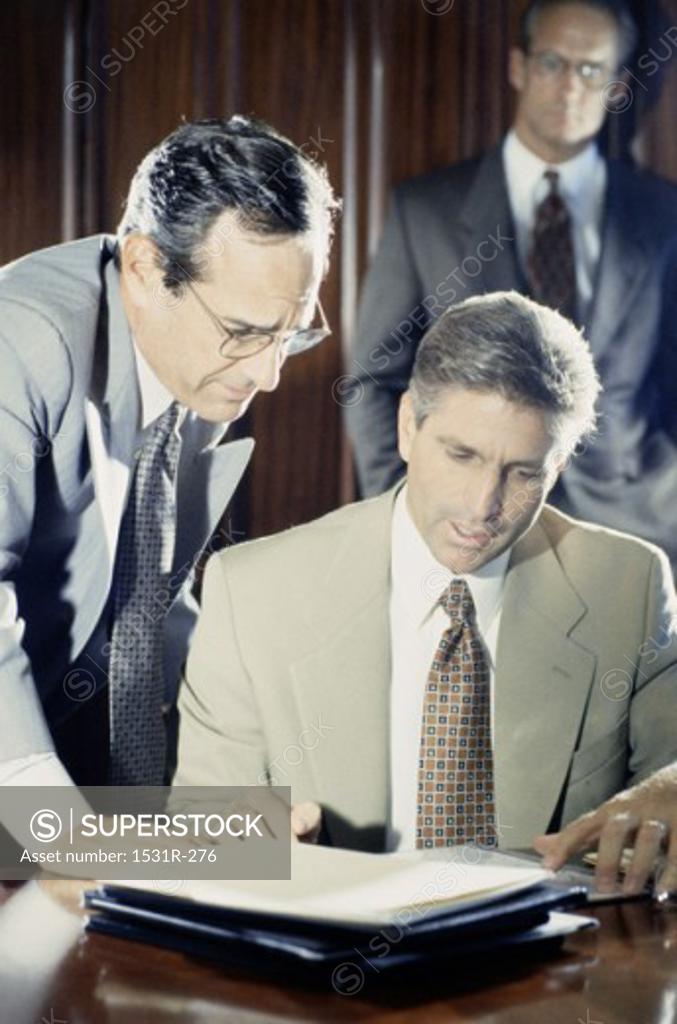 Stock Photo: 1531R-276 Two businessmen discussing in an office