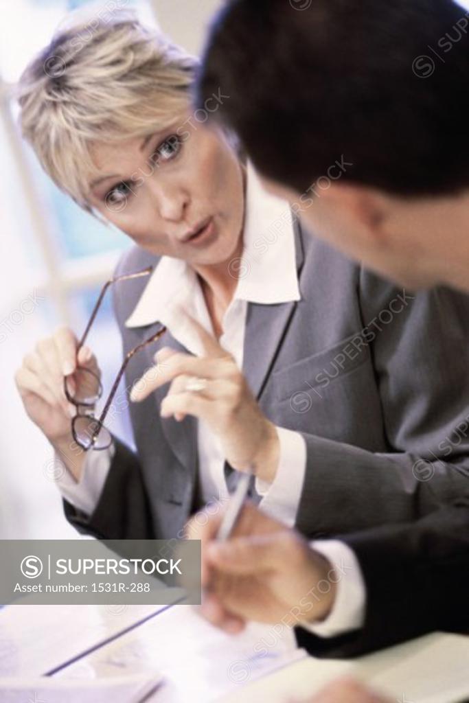 Stock Photo: 1531R-288 Businesswoman talking to a businessman