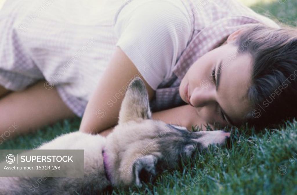 Stock Photo: 1531R-296 Girl lying on grass with her dog