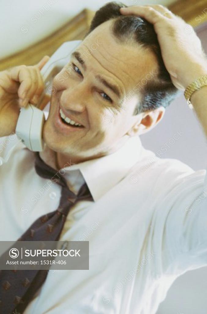 Stock Photo: 1531R-406 Portrait of a businessman talking on a landline telephone