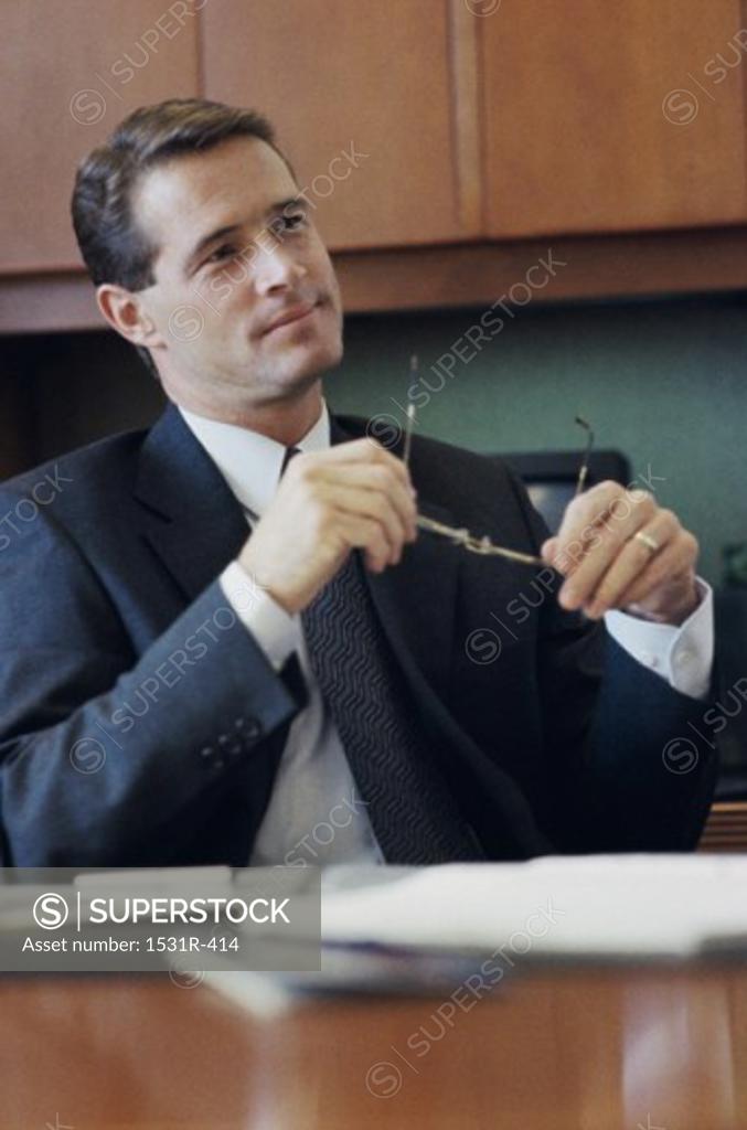 Stock Photo: 1531R-414 Businessman seated at a desk