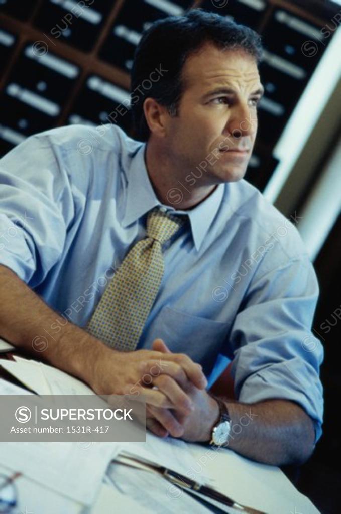 Stock Photo: 1531R-417 Businessman seated at a desk