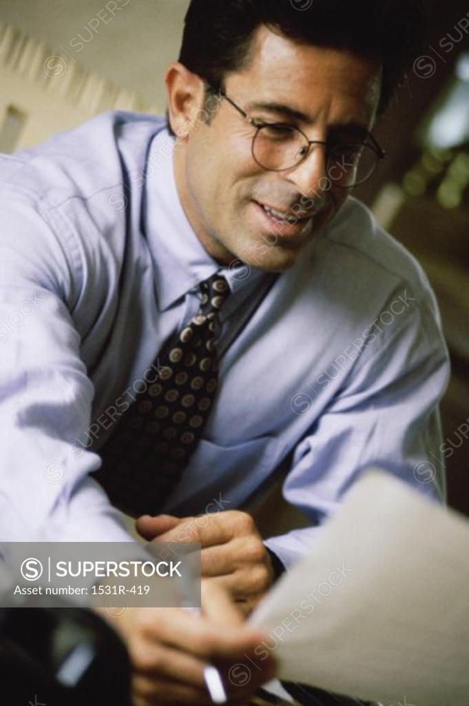 Stock Photo: 1531R-419 Businessman holding a sheet of paper