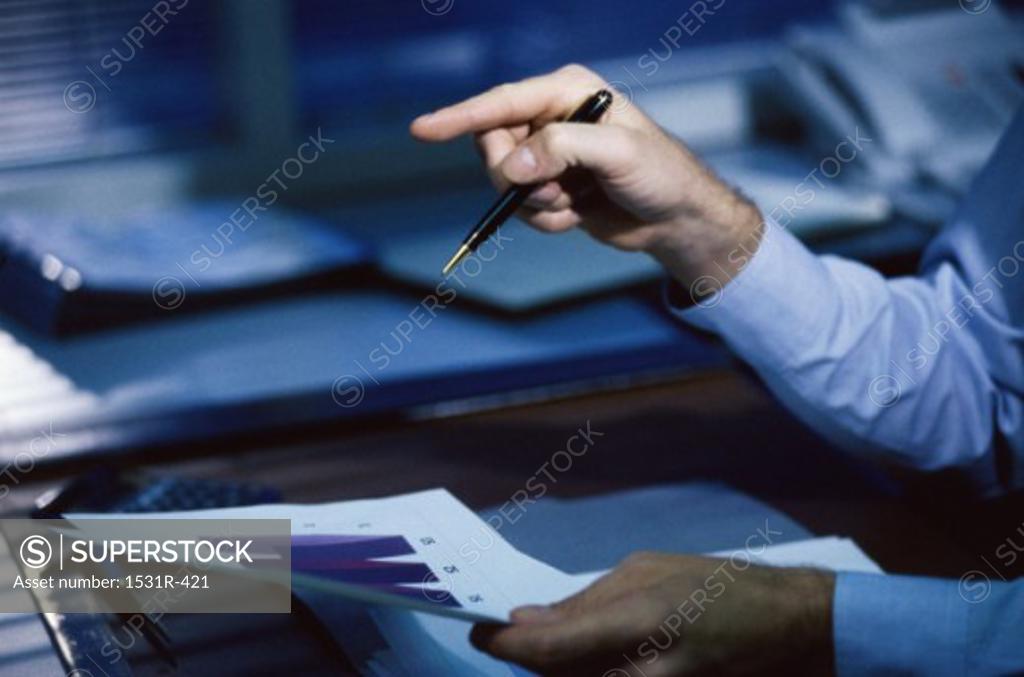 Stock Photo: 1531R-421 Businessman's hand holding a pen pointing forward