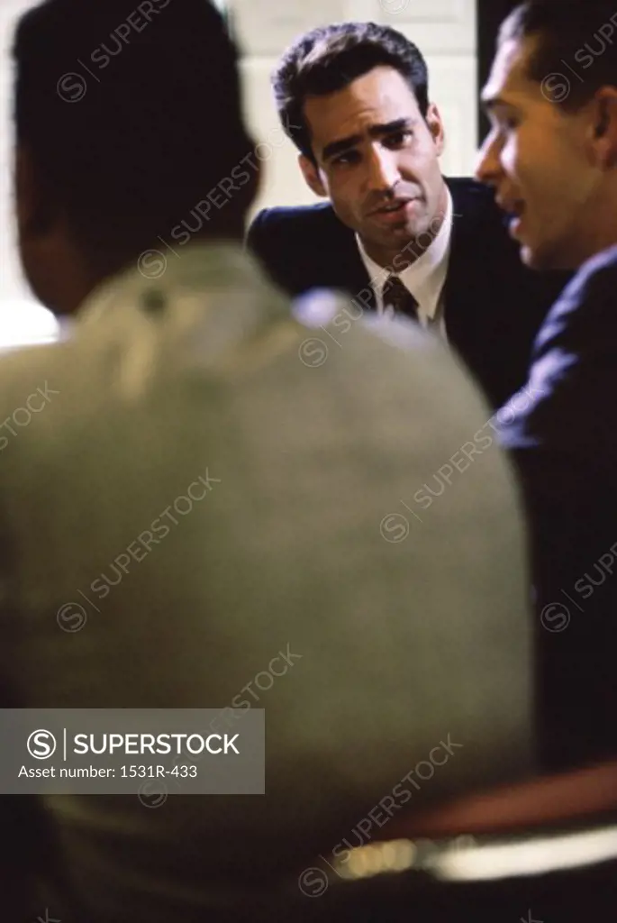Three businessmen together in an office