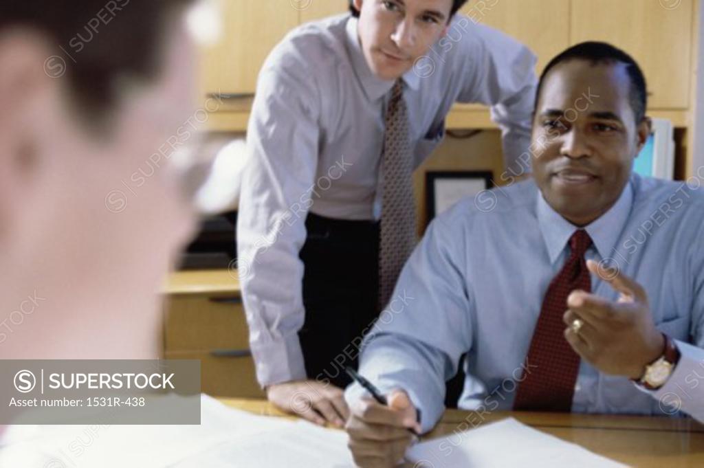 Stock Photo: 1531R-438 Three businessmen discussing in an office