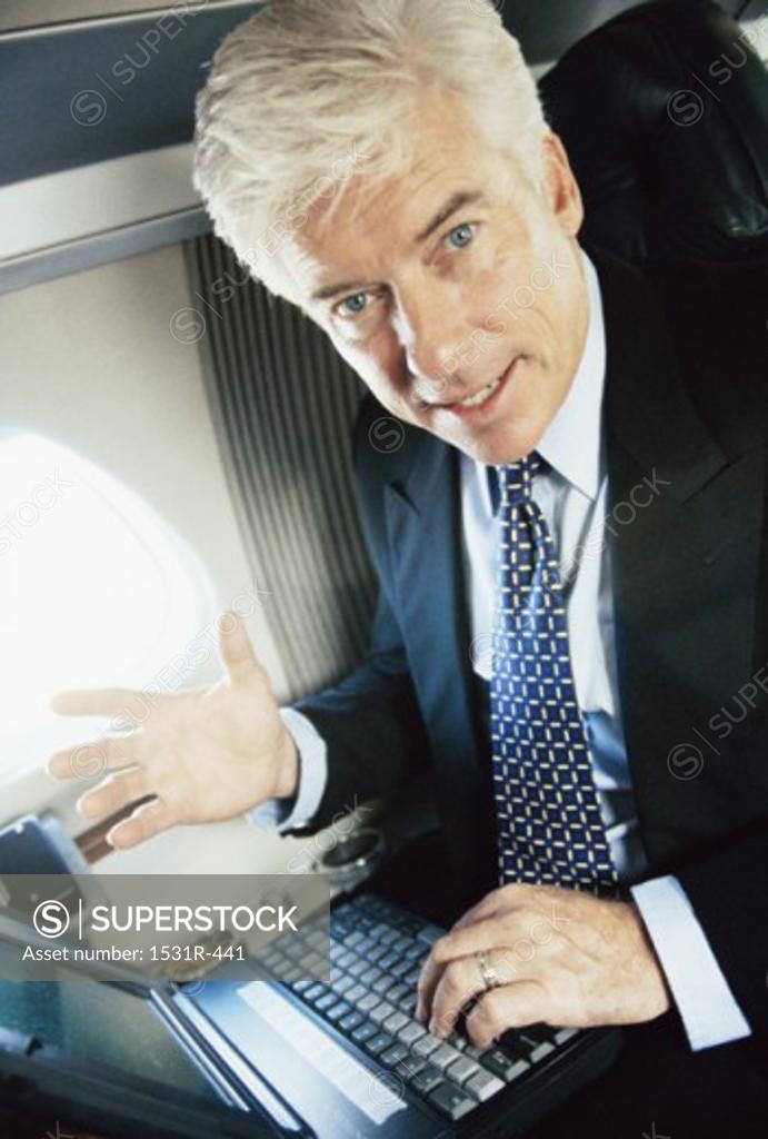 Stock Photo: 1531R-441 Portrait of a businessman using a laptop
