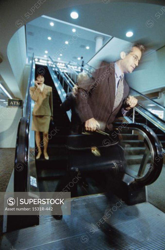 Stock Photo: 1531R-442 Business executives on an escalator