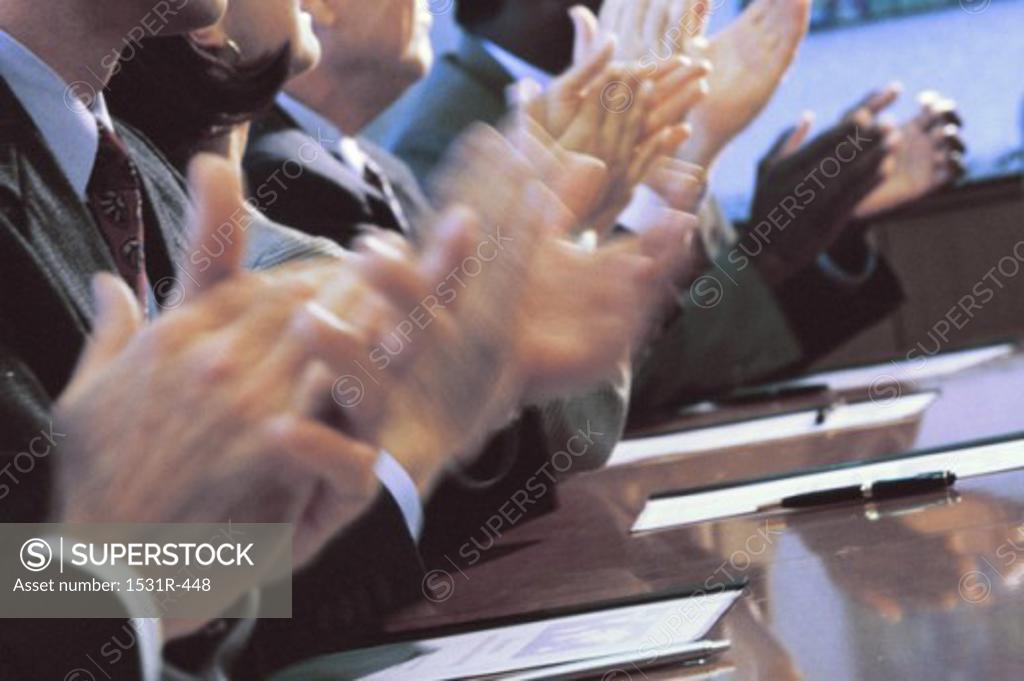Stock Photo: 1531R-448 Business executives clapping in an office