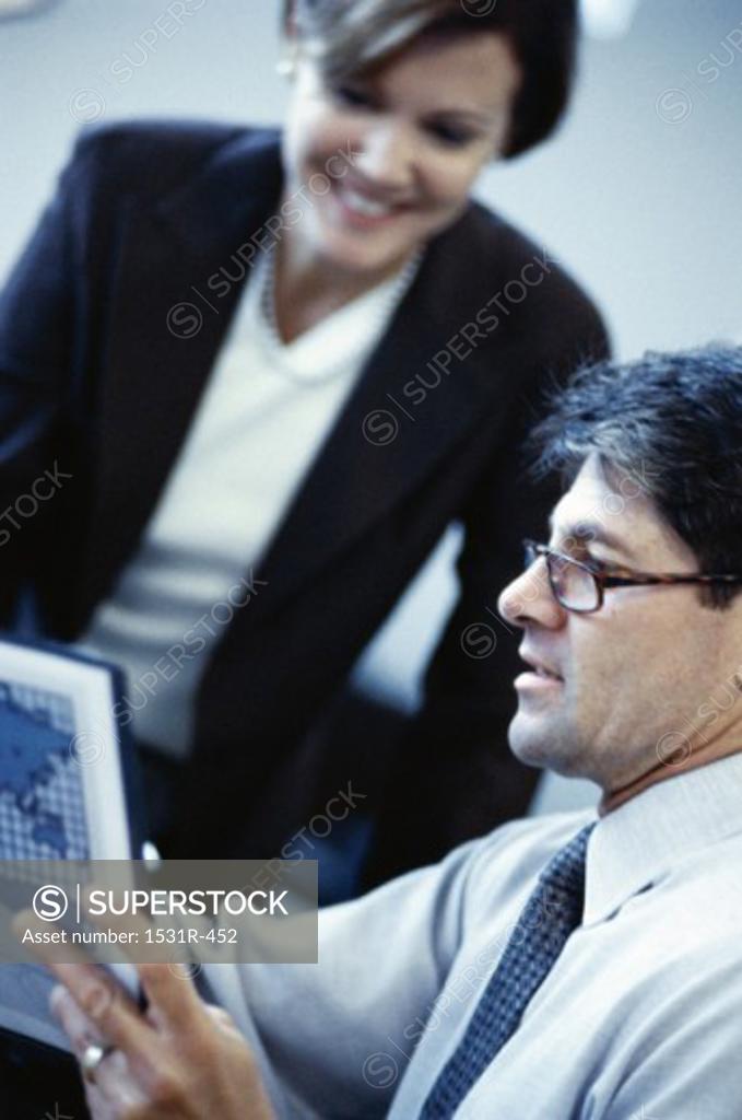 Stock Photo: 1531R-452 Businessman and a businesswoman in an office