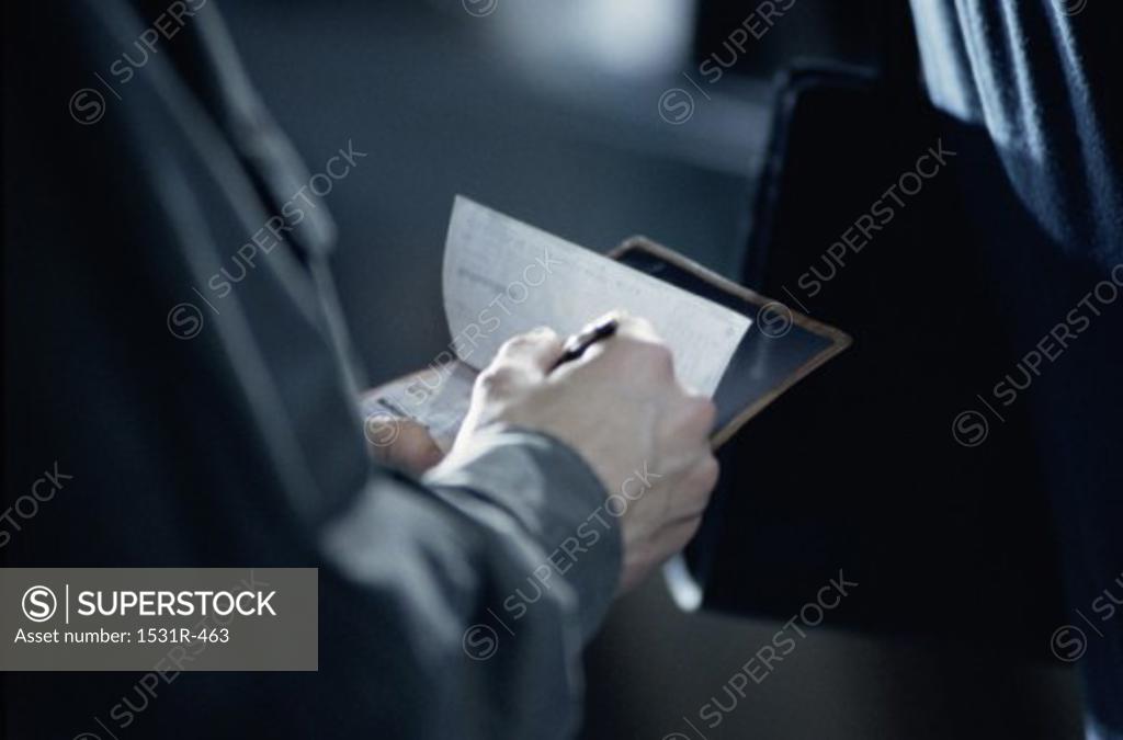 Stock Photo: 1531R-463 Person writing a check