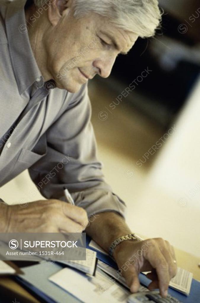 Stock Photo: 1531R-464 Side profile of a man writing a check