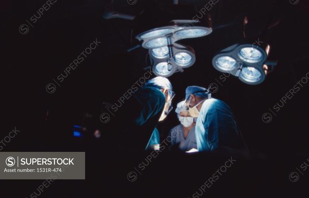 Stock Photo: 1531R-474 Surgeons operating in an operating room