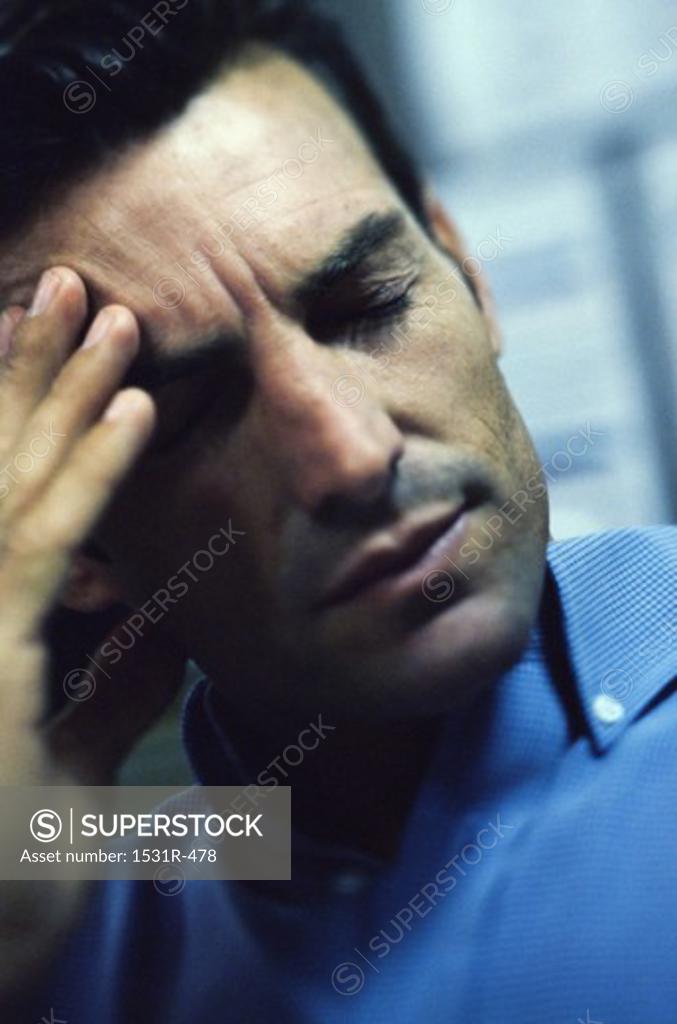 Stock Photo: 1531R-478 Man holding his forehead in pain