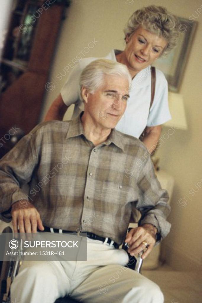 Stock Photo: 1531R-481 Senior woman pushing a senior man in a wheelchair