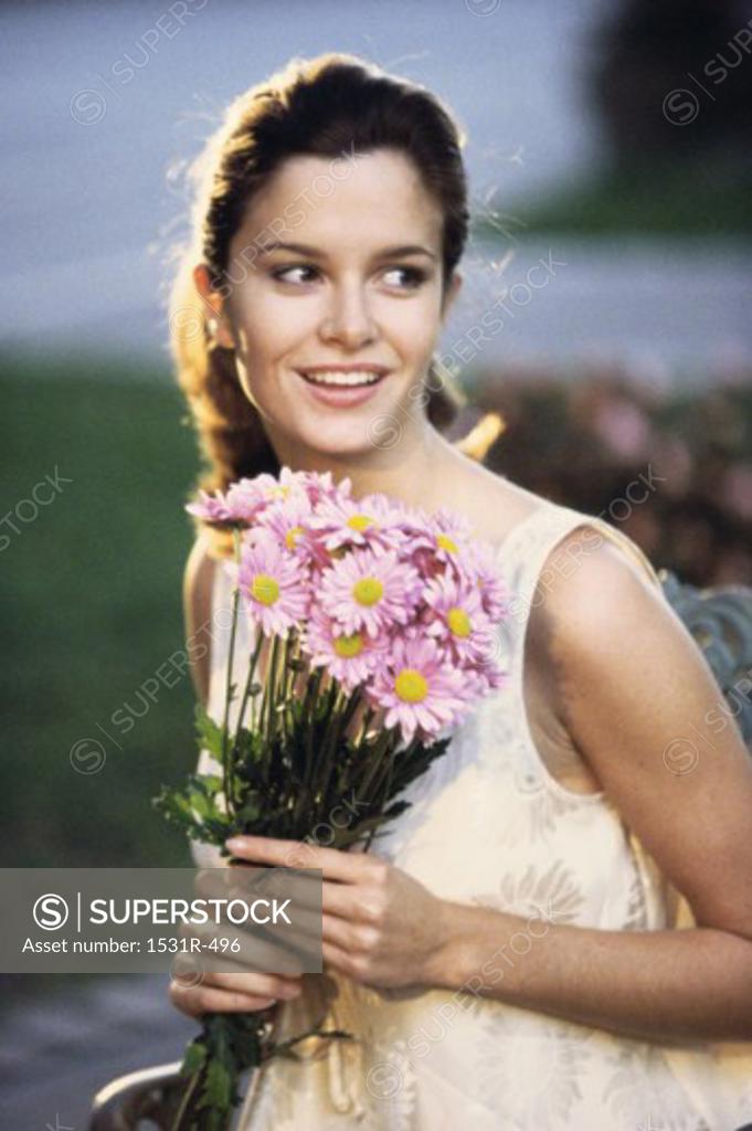 Stock Photo: 1531R-496 Young woman holding a bouquet of flowers