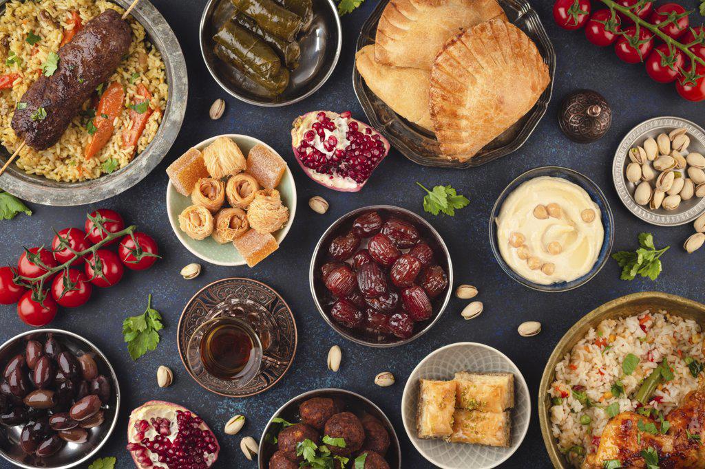 Ramadan kareem Iftar party table with assorted festive traditional Arab dishes, sweets, dates