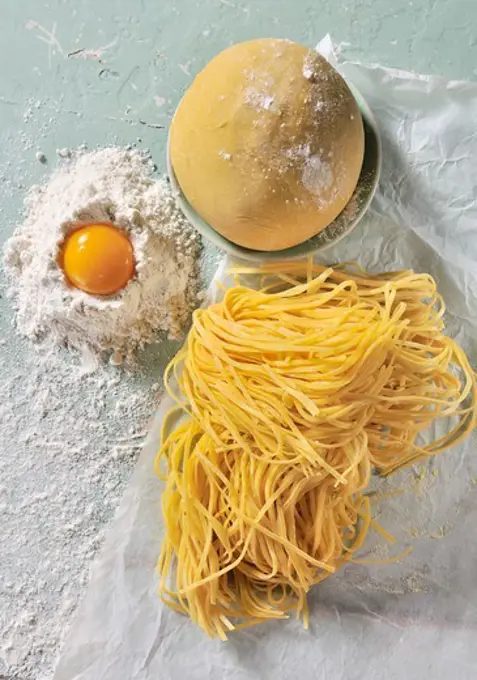 Pasta dough, flour, egg and homemade tagliatelle