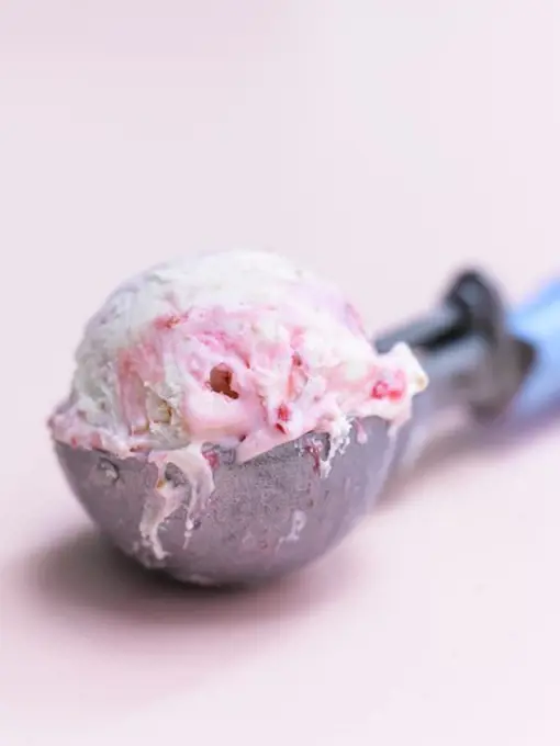 Raspberry ice cream in an ice cream scoop