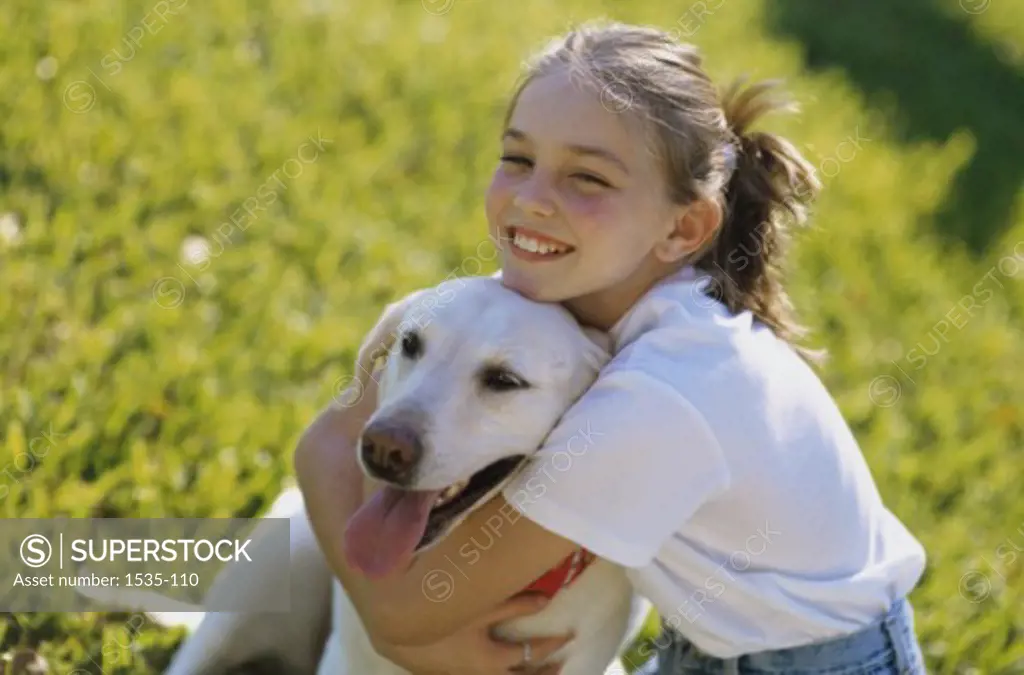 Side view of a girl holding a dog