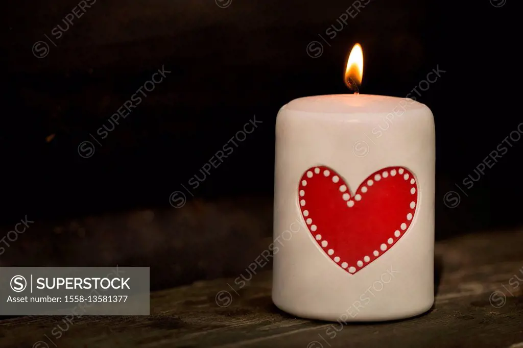 White table candle with red heart and flame