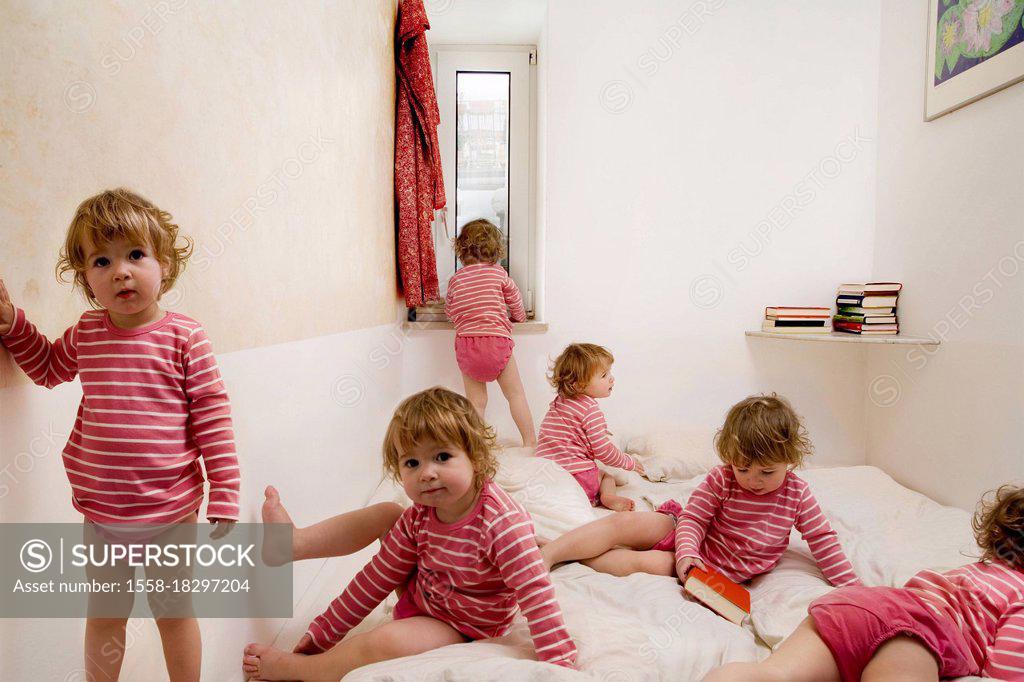 Stock Photo: 1558-18297204 Child crawls across bed