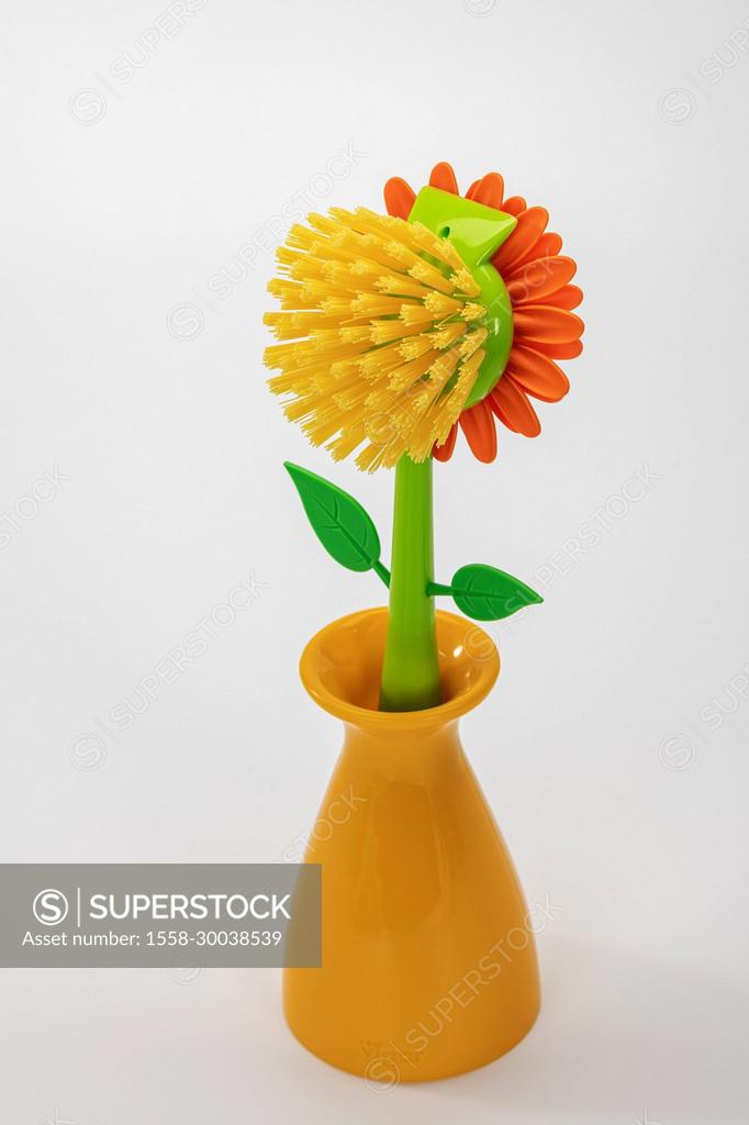 Decorative yellow dish brush flower shaped in vase by VIGAR 'Flower Power',  white background, - SuperStock