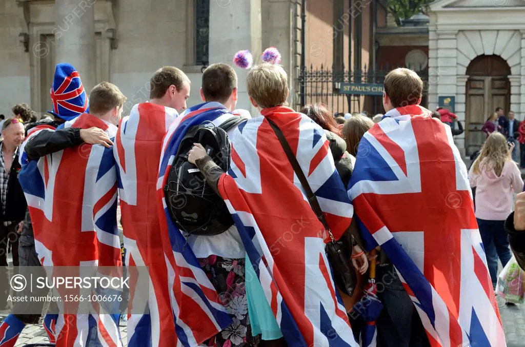 A group of revellers draped in Union Jack flags, Covent Garden, London, UK