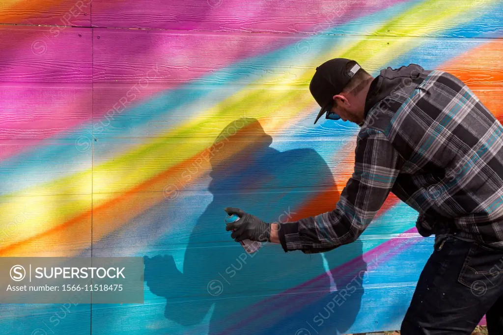 Detroit, Michigan - Street artist Phybr (Ken Dushane) paints a mural on three vacant lots where houses had been abandoned and then demolished. The Thr...