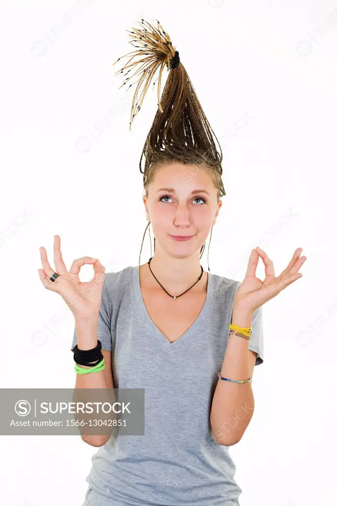Blonde girl with funny expression doing yoga with pigtails raised  vertically on her head. - SuperStock