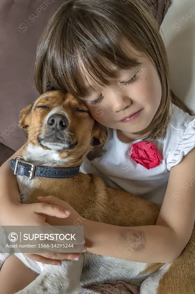 A toddler girl and her pet with closed eyes.