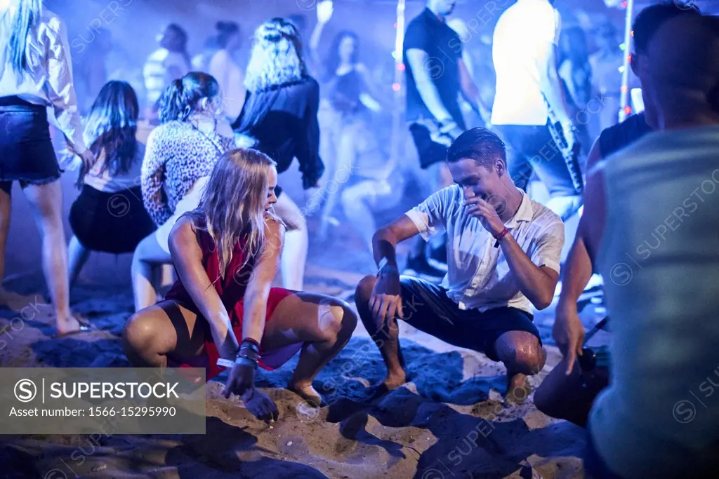 Greece, Crete, Chersonissos, couple dancing at Beach Party, flirting
