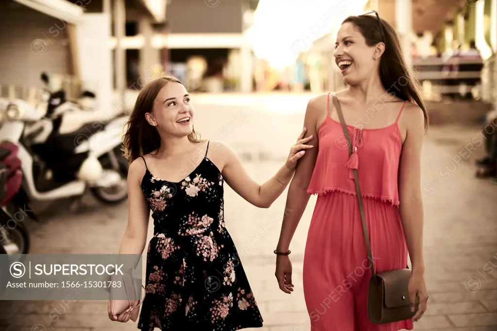 two women walking in streets of holiday destination Chersonisoss, Crete, Greece