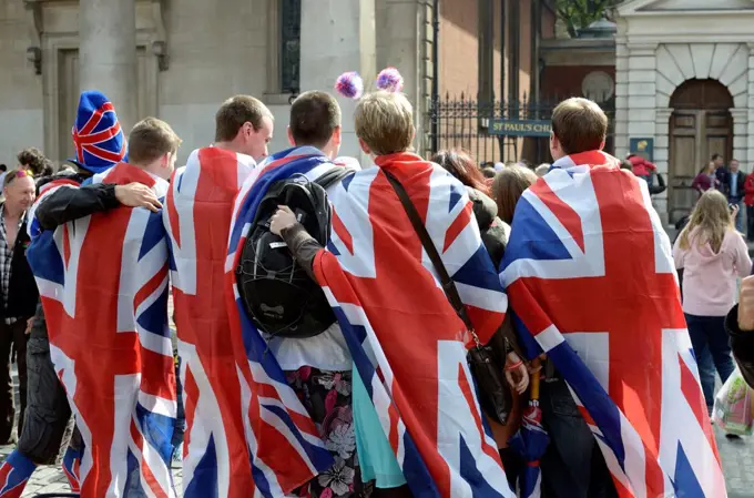 A group of revellers draped in Union Jack flags, Covent Garden, London, UK